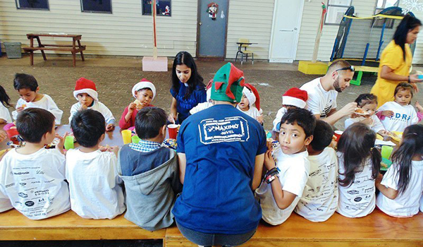 volunteer feeding kids in orphanage