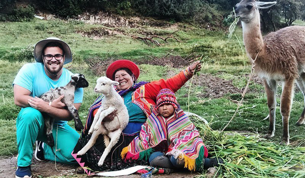 volunteer carrying baby sheep