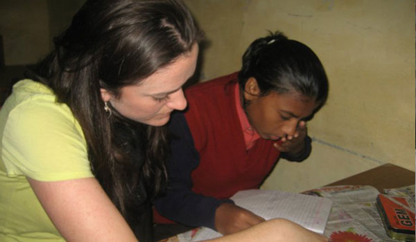 volunteer helping student to learn
