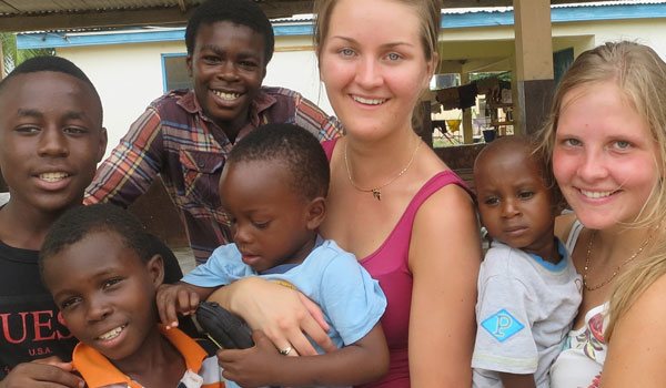 volunteers with children in tanzania orphanage
